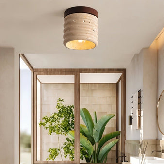 "A retro-inspired ceiling light with a travertine shade and a wooden base, mounted on a kitchen ceiling, providing a warm, ambient glow."