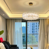 "A ring chandelier with handcrafted glass petals in an apartment living room."