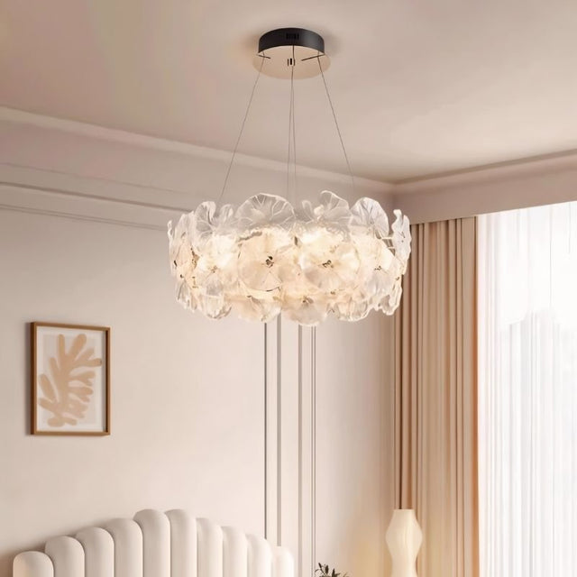 "A ring chandelier with handcrafted glass petals in a bedroom setting."