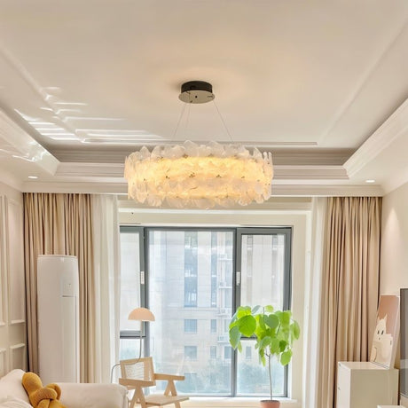 "A ring chandelier with handcrafted glass petals in a living room."