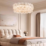 "A ring chandelier with handcrafted glass petals in a master bedroom."
