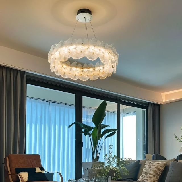 "A ring chandelier with handcrafted glass petals in a modern living room."