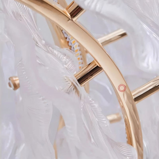 "A close-up detail of a gold ring chandelier with handcrafted glass petals."