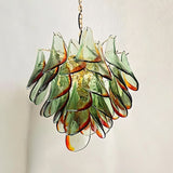 "Close-up of a Murano glass chandelier with green and red accents, showing the intricate glass details."