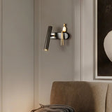 "A black and gold bedside reading lamp with a figurine on a living room wall."