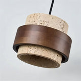 "Close-up of a modern cylindrical pendant light featuring natural stone and dark wood, showcasing the texture and detail."