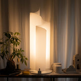 Stellora Table Lamp: Modern Spiral Design & Warm Illumination on a wooden table with decor, ideal for contemporary indoor lighting.
