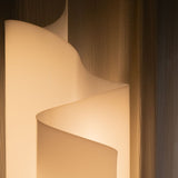 Top view of Stellora Table Lamp's spiral form, emphasizing its sculptural design and warm illumination for modern interiors.