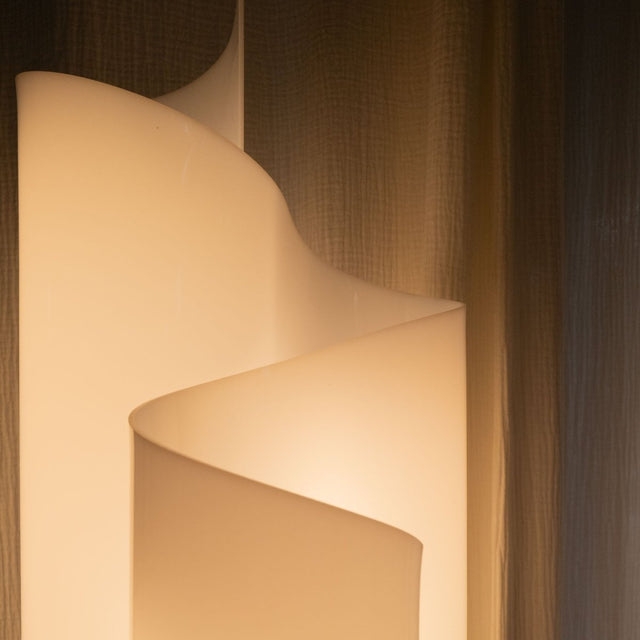 Top view of Stellora Table Lamp's spiral form, emphasizing its sculptural design and warm illumination for modern interiors.