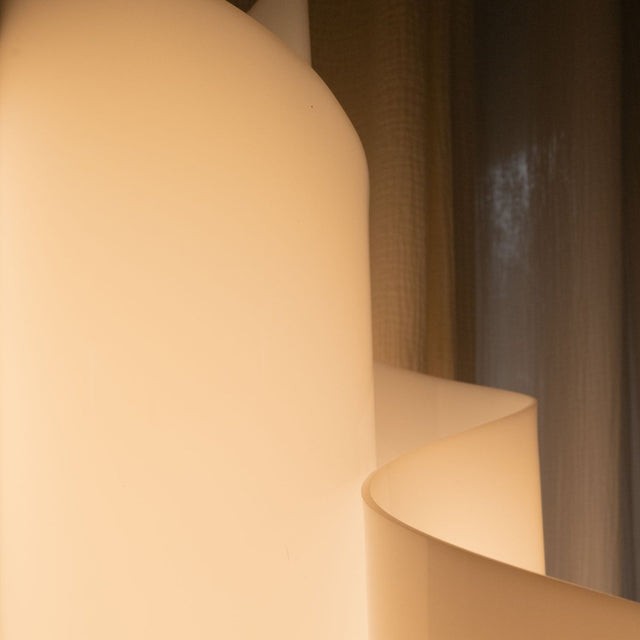 Detail of the Stellora Table Lamp's smooth acrylic curves, radiating soft light for elegant indoor ambient lighting.