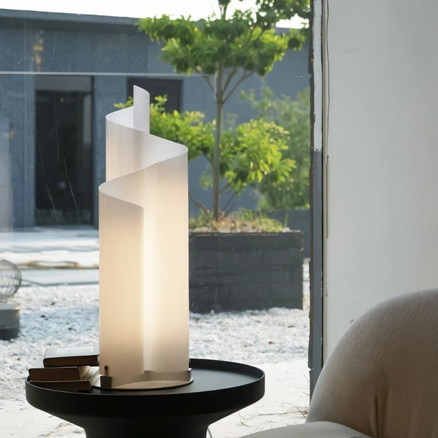 Stellora Table Lamp placed on a black side table near a window, blending modern design with natural light in a stylish living space.