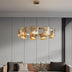 # Alt Text

Modern brass pendant chandelier with geometric amber glass shades suspended above a contemporary sofa.