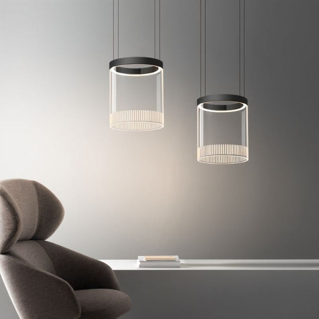 "Pendant light with a cylindrical glass shade and black aluminum finish, perfect for adding a sophisticated touch to dining tables or modern kitchen islands."