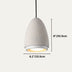 Teardrop-shaped concrete pendant light with warm interior glow against neutral background.