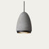 Gray concrete pendant light with black metal rim and warm interior glow on white background.