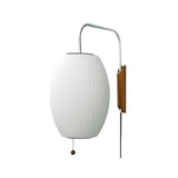 "A sleek, modern wall lamp with a luxurious, oval-shaped silk shade, casting a soft, ambient glow."