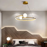 "A gold circular chandelier with two white spherical diffusers, hanging above a bed with a unique headboard in a modern bedroom."
