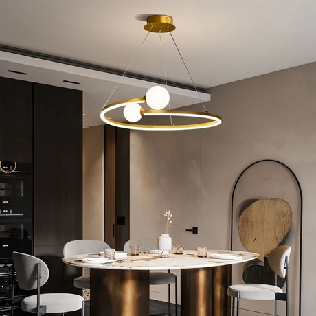 "A gold circular chandelier with two white spherical diffusers, hanging above a round dining table in a modern dining room."