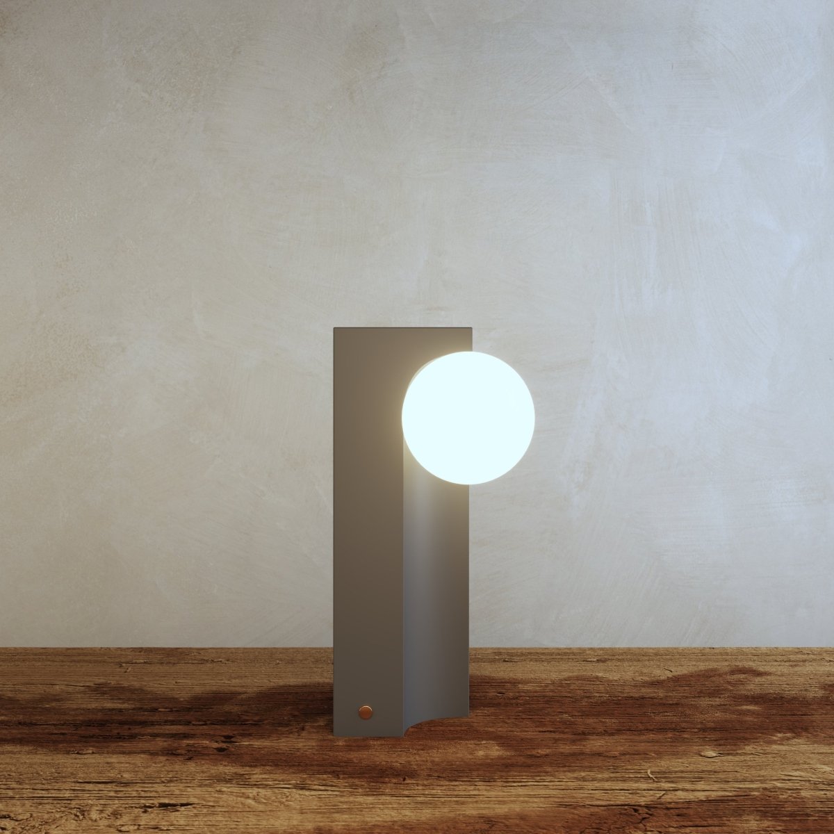 Teral Table Lamp glowing on rustic wooden surface, combining modern design with natural textures for stylish ambient lighting.