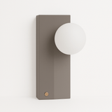 Teral Table Lamp with matte concrete base and frosted glass globe, ideal for modern ambient lighting in bedrooms or living rooms.