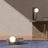Teral Table Lamps in upright and horizontal positions on modern surfaces, demonstrating versatile placement for ambient lighting.