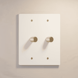 Two-gang white rotary dimmer switch with gold accents, ideal for clean and elegant lighting control.