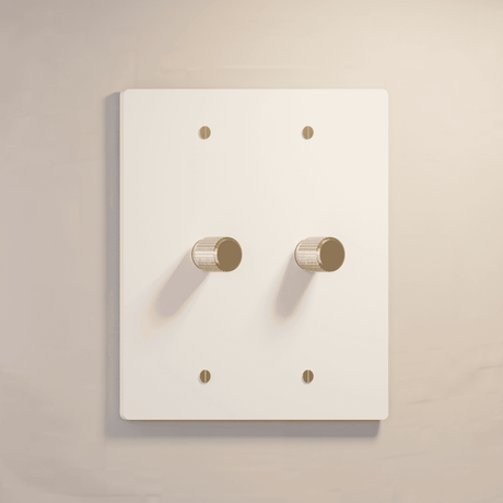 Two-gang white rotary dimmer switch with gold accents, ideal for clean and elegant lighting control.