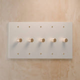 Five-gang white rotary dimmer switch with soft gold knobs, perfect for bright and elegant lighting control setups.