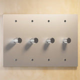 Four-gang silver rotary dimmer switch with knurled knobs, designed for modern lighting control in stylish interiors.