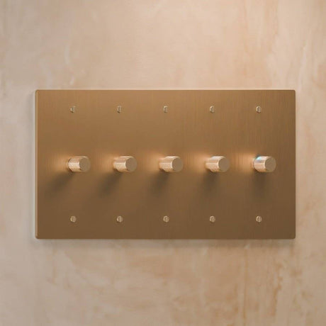 Five-gang light brass rotary dimmer switch with precision knurled knobs, perfect for large-scale lighting control in modern homes.