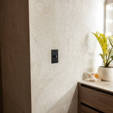 Single gang black rotary dimmer switch mounted near vanity, demonstrating The Brass 3-Way Rotary Dimmer Switch in use.