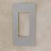 Light gray plastic electrical outlet wall plate with single rectangular opening