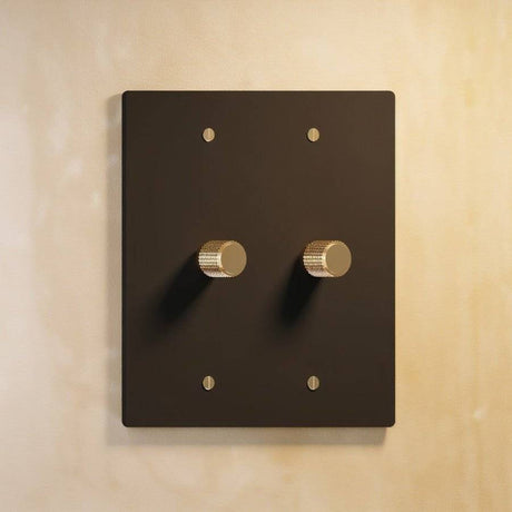 Two-gang The Brass Dimmer Switch - Open Box in matte black with brass knobs, ideal for contemporary lighting control.