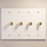 Four-gang The Brass Dimmer Switch - Open Box in white with brass knobs, perfect for luxury lighting systems.