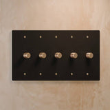 Five-gang The Brass Dimmer Switch - Open Box in matte black with brass knobs, designed for stylish lighting systems.