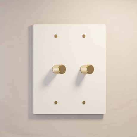 Two-gang The Brass Dimmer Switch - Open Box in white with brass knobs, ideal for bright and modern interiors.