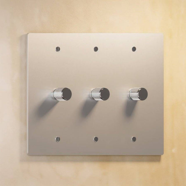 Three-gang silver The Brass Dimmer Switch - Open Box with metallic finish, offering precise lighting control.