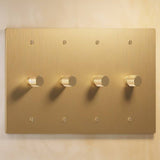 Four-gang polished brass The Brass Dimmer Switch - Open Box with knurled knobs, ideal for elegant multi-light setups.