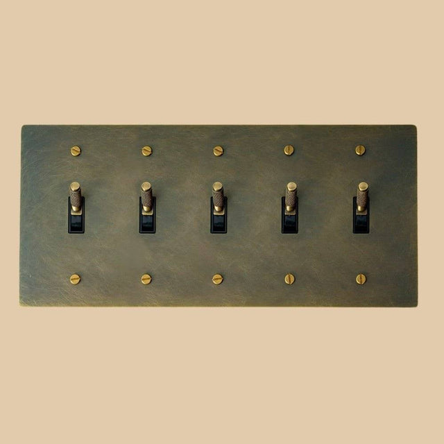Five-gang The Brass Toggle Switch (1 to 5 Gang) - Open Box in vintage brass with knurled toggles, perfect for expansive heritage lighting setups.