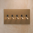 Five-gang The Brass Toggle Switch (1 to 5 Gang) - Open Box in brushed brass, designed for expansive lighting control in luxury spaces.