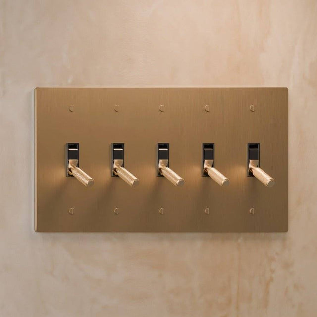 Five-gang The Brass Toggle Switch (1 to 5 Gang) - Open Box in brushed brass, designed for expansive lighting control in luxury spaces.