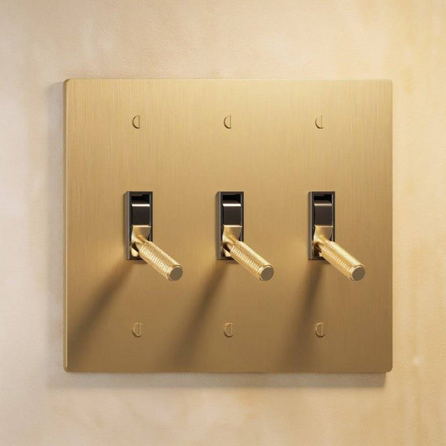 Triple gang The Brass Toggle Switch (1 to 5 Gang) - Open Box with brushed brass plate and three toggles, ideal for coordinated lighting control.