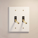 Double gang The Brass Toggle Switch (1 to 5 Gang) - Open Box in white finish with gold toggles, perfect for contemporary lighting control.