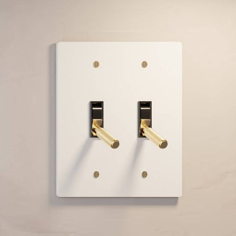 Double gang The Brass Toggle Switch (1 to 5 Gang) - Open Box in white finish with gold toggles, perfect for contemporary lighting control.