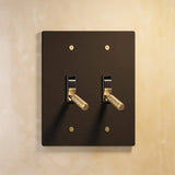 Double gang The Brass Toggle Switch (1 to 5 Gang) - Open Box in black with gold toggles, ideal for bold, contemporary lighting schemes.