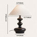 Black table lamp with cream linen shade on neutral background, showing dimensions and proportions.