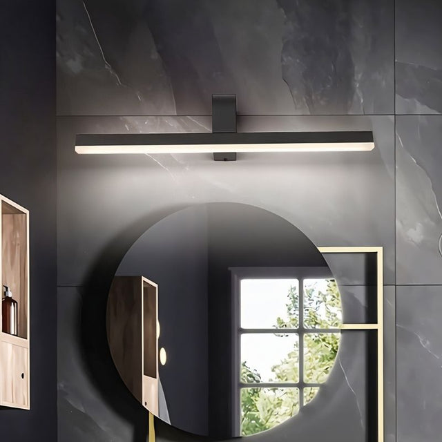 "A modern, dark finish LED vanity light illuminating a round bathroom mirror."
