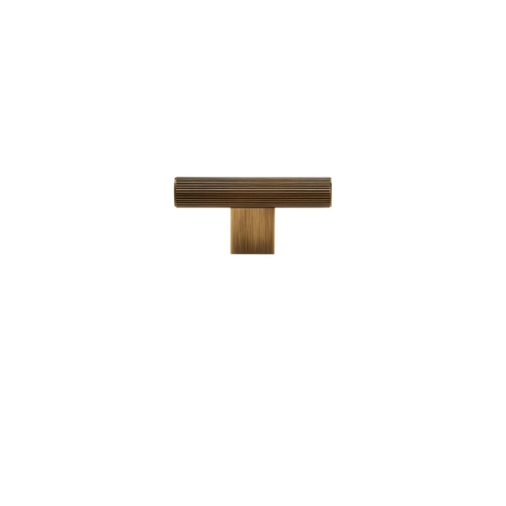 "A modern antique brass knob with a sleek ribbed texture, ideal for cabinet doors and drawers."