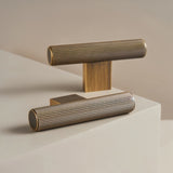 "Pair of modern brass pull bars with a sleek ribbed texture, ideal for cabinet doors, drawers, and wardrobe panels in modern and transitional interiors."
