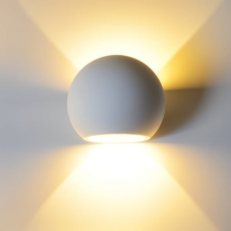 "Spherical wall lamp made from gypsum and aluminum, casting soft, multidirectional light, perfect for modern interiors."